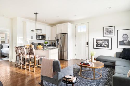 a living room and kitchen with a couch and a table at The Hart Suites by AvantStay in Nashville