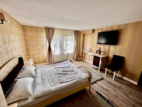 Un pat sau paturi într-o cameră la Complex Popas Pacurari