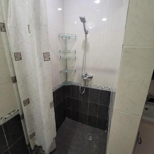 a bathroom with a shower with a tiled floor at Family home in Yerevan