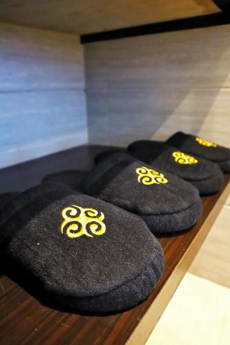 a row of black towels with gold symbols on them at Grand Tjokro Premiere Bandung in Bandung