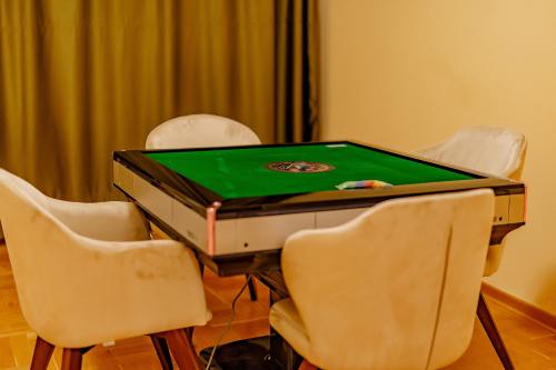a ping pong table with four chairs around it at AirStar in Surčin