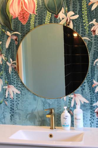 a bathroom sink with a mirror on top of it at House on Ingmarsö - in Stockholm archipelago in Ingmarsö