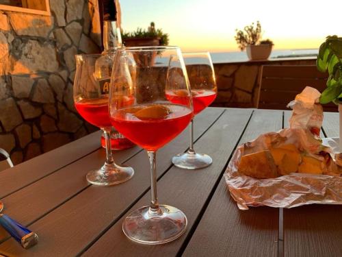 trois verres à vin assis au-dessus d'une table en bois dans l'établissement Casa di charme Bastioni, à Gallipoli