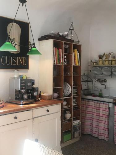 a kitchen with a book shelf filled with dishes at Bella Casa Cantoniera in Caravonica
