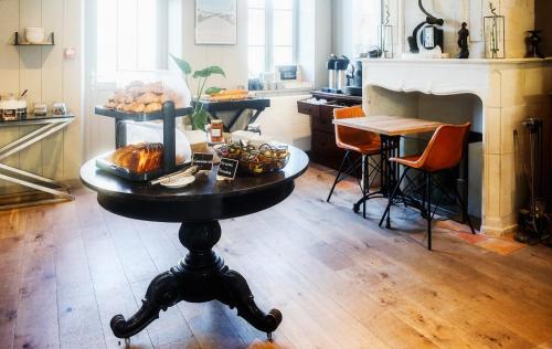 a table with a tray of food on it in a kitchen at Hotel Napoleon in Île dʼAix