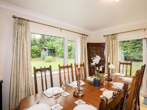 a dining room with a table and a large window at Queen's Cottage in Colwyn Bay