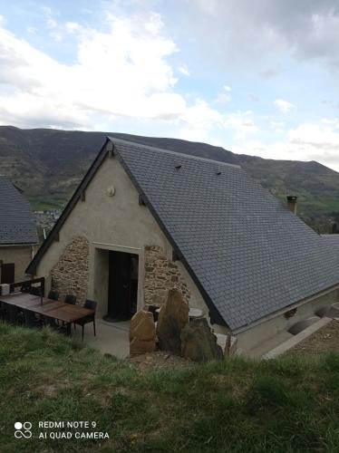 a stone building with a bench and a roof at Chalet Etxola in Ens