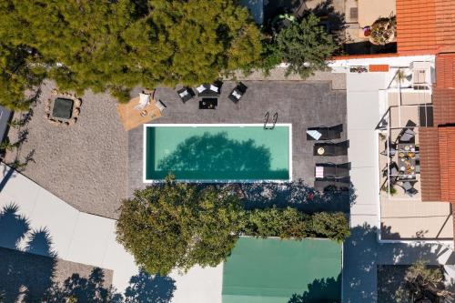 an overhead view of a pool with trees and buildings at Ixian Bliss Pool Villa in Ialysos