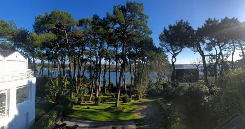 an aerial view of a yard with trees and a lake at La Villa Bel Ange Hotel in Saint-Philibert