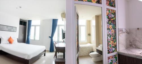 a bedroom with a bed and a bathroom with a tub at Queen Palace - Dubai Hotel Danang in Da Nang