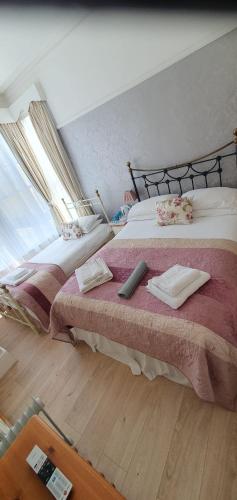 a bedroom with two beds with pillows on them at St Davids & Moorfield Hotels Chapel Street in Llandudno