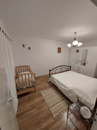 a bedroom with a bed and two chairs in it at Casa Irma in Žminj