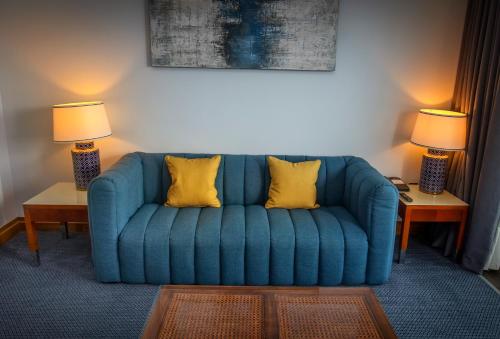 a blue couch in a room with two lamps at The Quay Hotel and Spa in Conwy