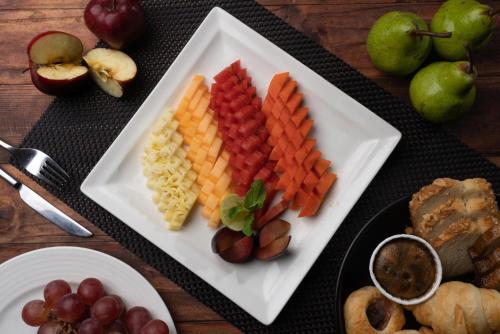 a plate of fruit and vegetables on a table at Bengaluru Marriott Hotel Whitefield in Bengaluru