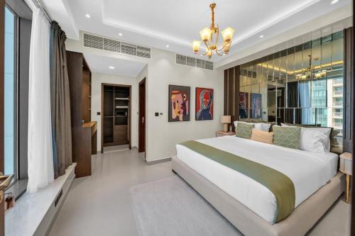a bedroom with a large bed and a chandelier at 29Blvd BurjView in Dubai