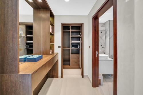 a bathroom with a wooden counter and a sink at 29Blvd BurjView in Dubai