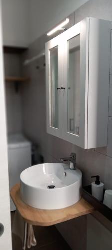 a bathroom with a white sink and a mirror at LA RAJA in Scilla