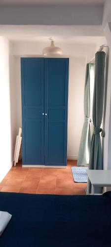 a blue cabinet in a room with a curtain at LA RAJA in Scilla