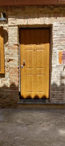 a wooden door on a building with a stone wall at LA RAJA in Scilla