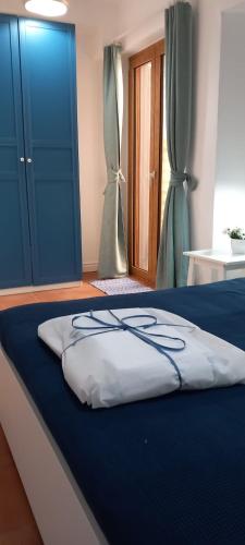 a bed with a blue and white blanket on it at LA RAJA in Scilla
