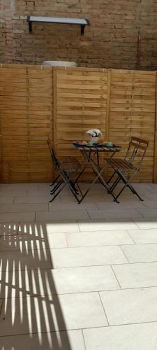 a table and chairs in a room with a wall at LA RAJA in Scilla