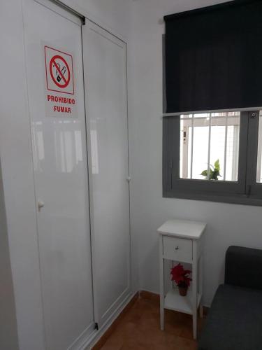 a room with a door with a no smoking sign on it at Alemar I in Fuengirola