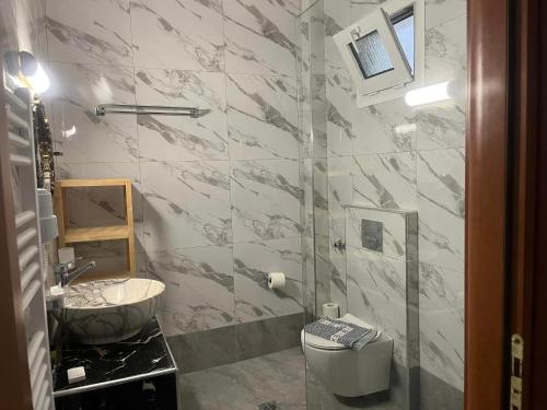 a bathroom with a sink and a toilet at Villa Askamnia and Suites in Nikiti