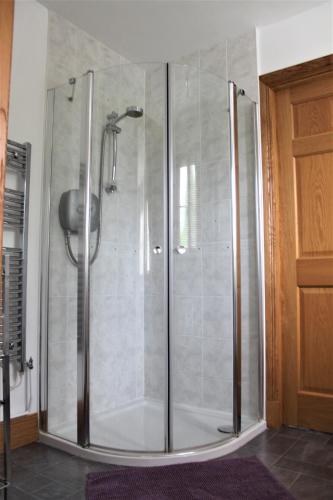 a shower with a glass door in a bathroom at Langdale Lodge at Langdale Lakes, LINCOLN LN3 5BB in Lincoln