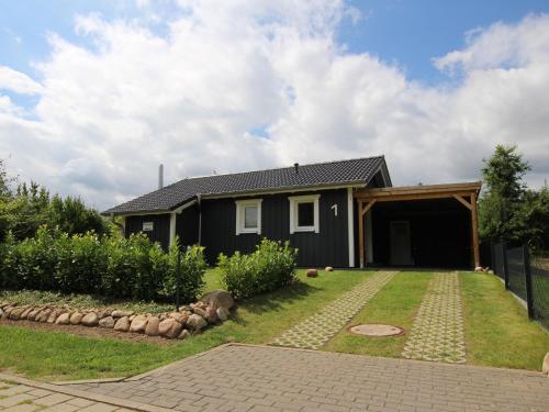 a house with a garage and a yard at Ferienhaus Tversted in Zarrentin in Zarrentin