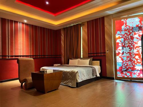 a hotel room with a bed and a large window at Vogue Boutique Motel in Yangmei