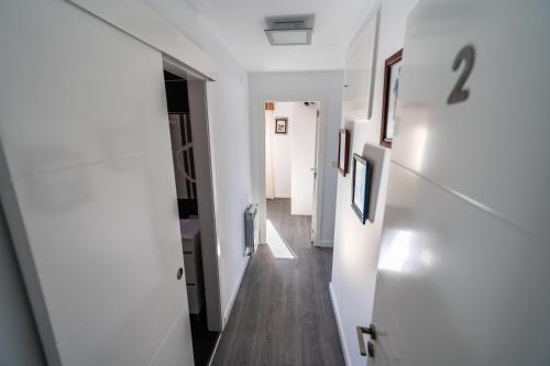 a hallway with white walls and wooden floors at Casa da Vasca in Malpica