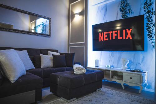 a living room with a couch and a television at BELVEDERE Luxury Apartment, view on the Lucca Walls in Lucca