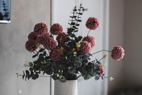 a vase filled with flowers in a room at BELVEDERE Luxury Apartment, view on the Lucca Walls in Lucca