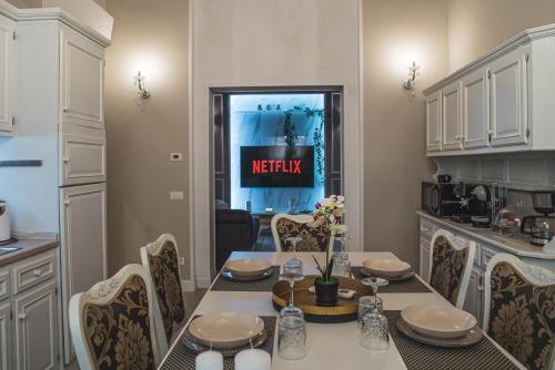 a kitchen and dining room with a table and chairs at BELVEDERE Luxury Apartment, view on the Lucca Walls in Lucca