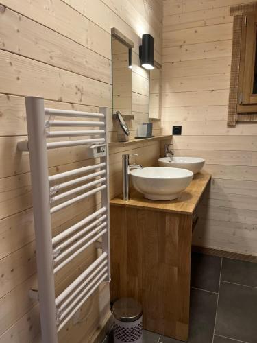 a bathroom with two sinks and a mirror at Chalet L'Ôbresse in La Bresse