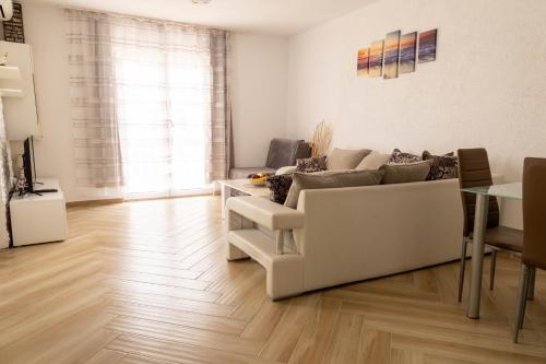 a living room with a couch and a table at Apartmani Marojević, Bar in Bar
