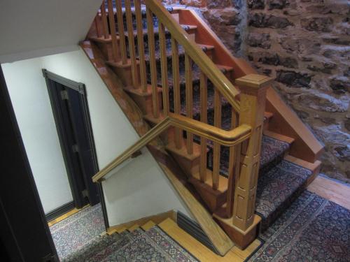 a wooden staircase in a room with a stone wall at Hotel Épik Montréal in Montréal