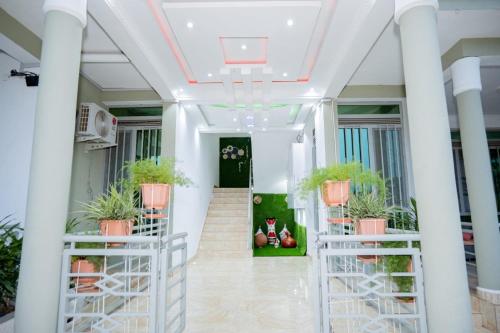 a hallway with potted plants in a building at The city Block Apartment in Bujumbura