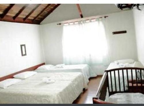 Un ou plusieurs lits dans un hébergement de l'établissement Pousada Capão do Índio
