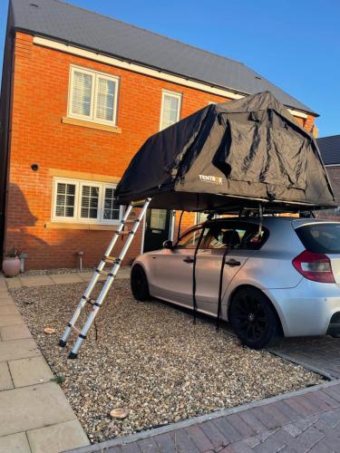 a ladder and an umbrella on top of a car at River tents 