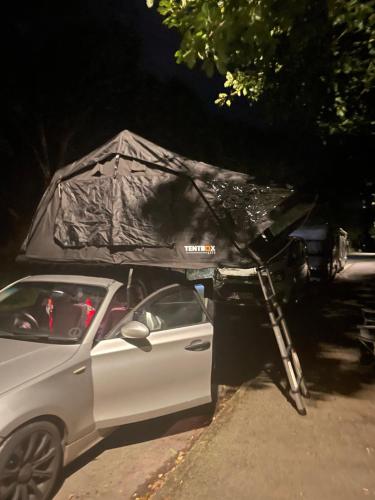 a car with a tent on the side of a road at River tents 