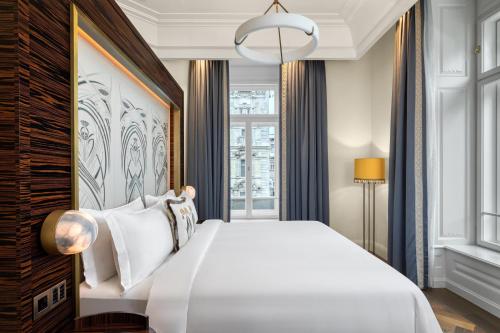 a bedroom with a large white bed and a window at Matild Palace, a Luxury Collection Hotel in Budapest