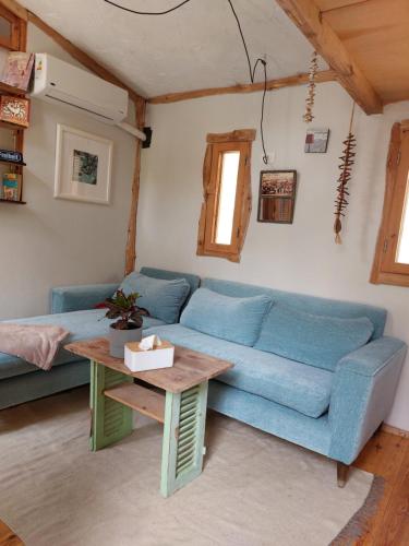 a living room with a blue couch and a table at Barefoot by Barefoot in Tunis in ‘Izbat an Nāmūs