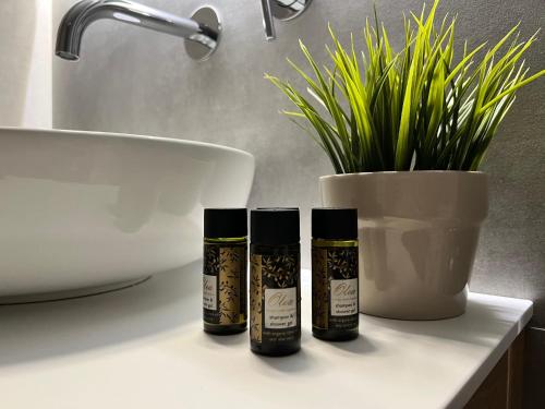 three bottles of essential oils sitting on a bathroom counter at Tramontana House1 in Skiathos