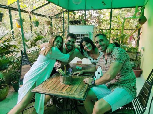 a group of people sitting at a table on a patio at Max Guest House in Agra