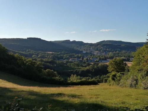 a view of a valley with hills and trees at Le belvédere Mouxois, SPA privatif, vue Morvan in Moux-en-Morvan