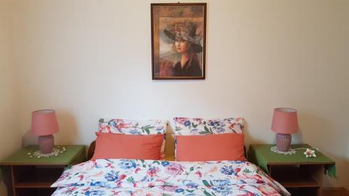 a bedroom with a bed and a painting on the wall at SWIM and CLIMB BAŠKA HOLIDAY HOUSE - island KRK in Draga
