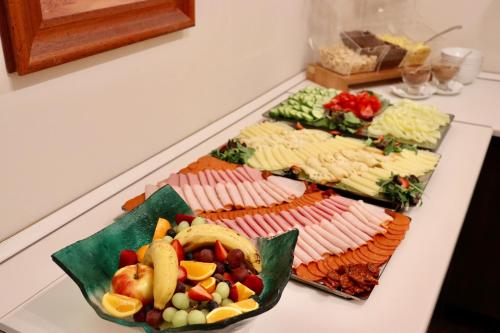 a buffet of different types of food on a table at Hotel La Riva in Siófok