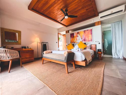 a bedroom with two beds and a ceiling fan at Wonders Beach Boutique Hotel in Mont Choisy