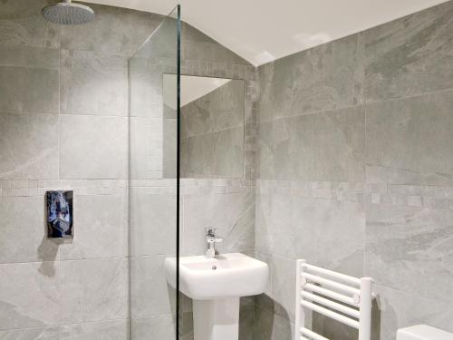 a bathroom with a toilet and a sink and a shower at Bowfell in Ambleside